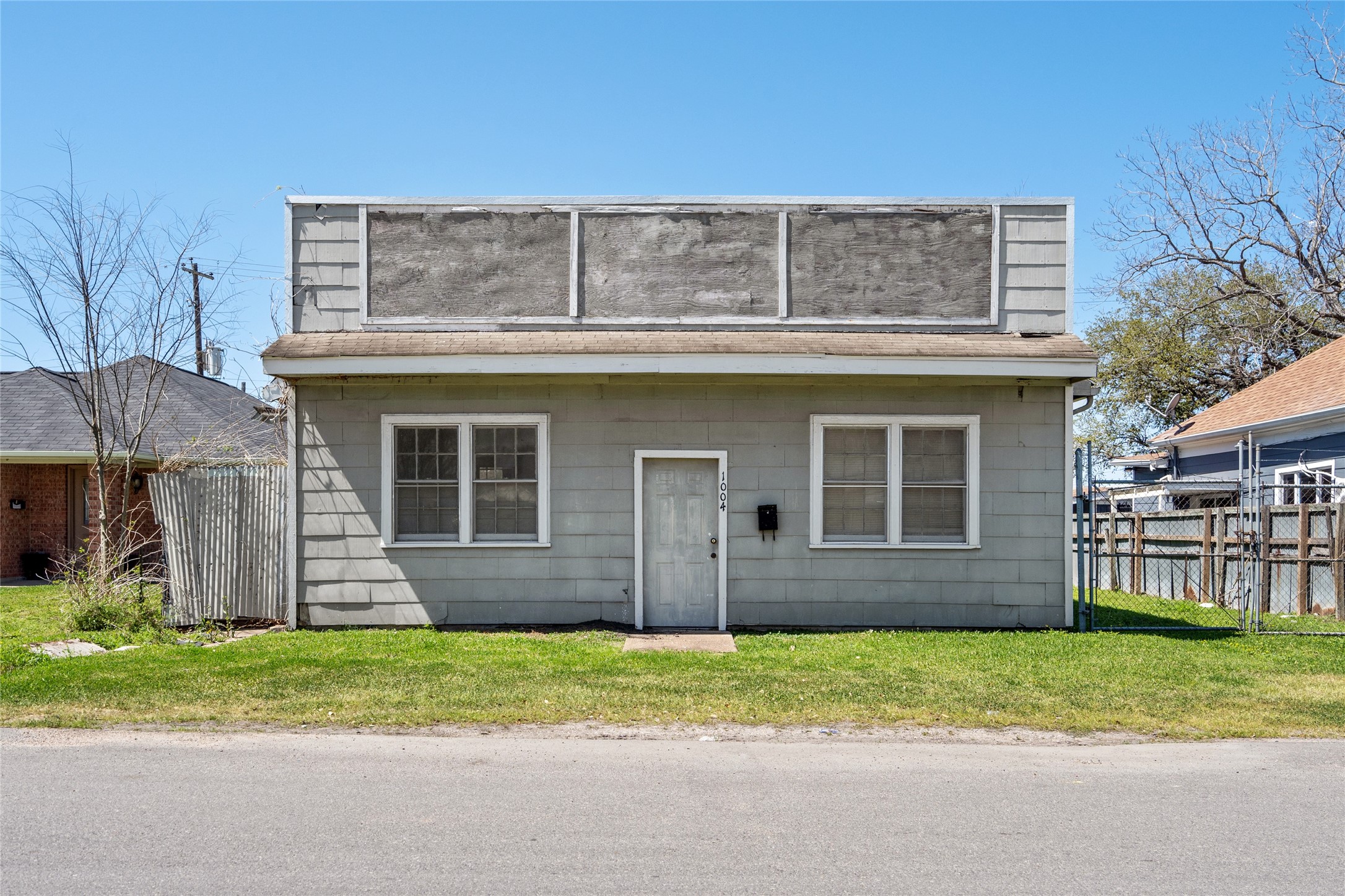 1004 Houston Street Rosenberg, TX 77471 - Photo 12 of 18 Direct front view of the building situated on the lot. Highlights the property's street-facing presence, offering excellent potential for future development or commercial use.