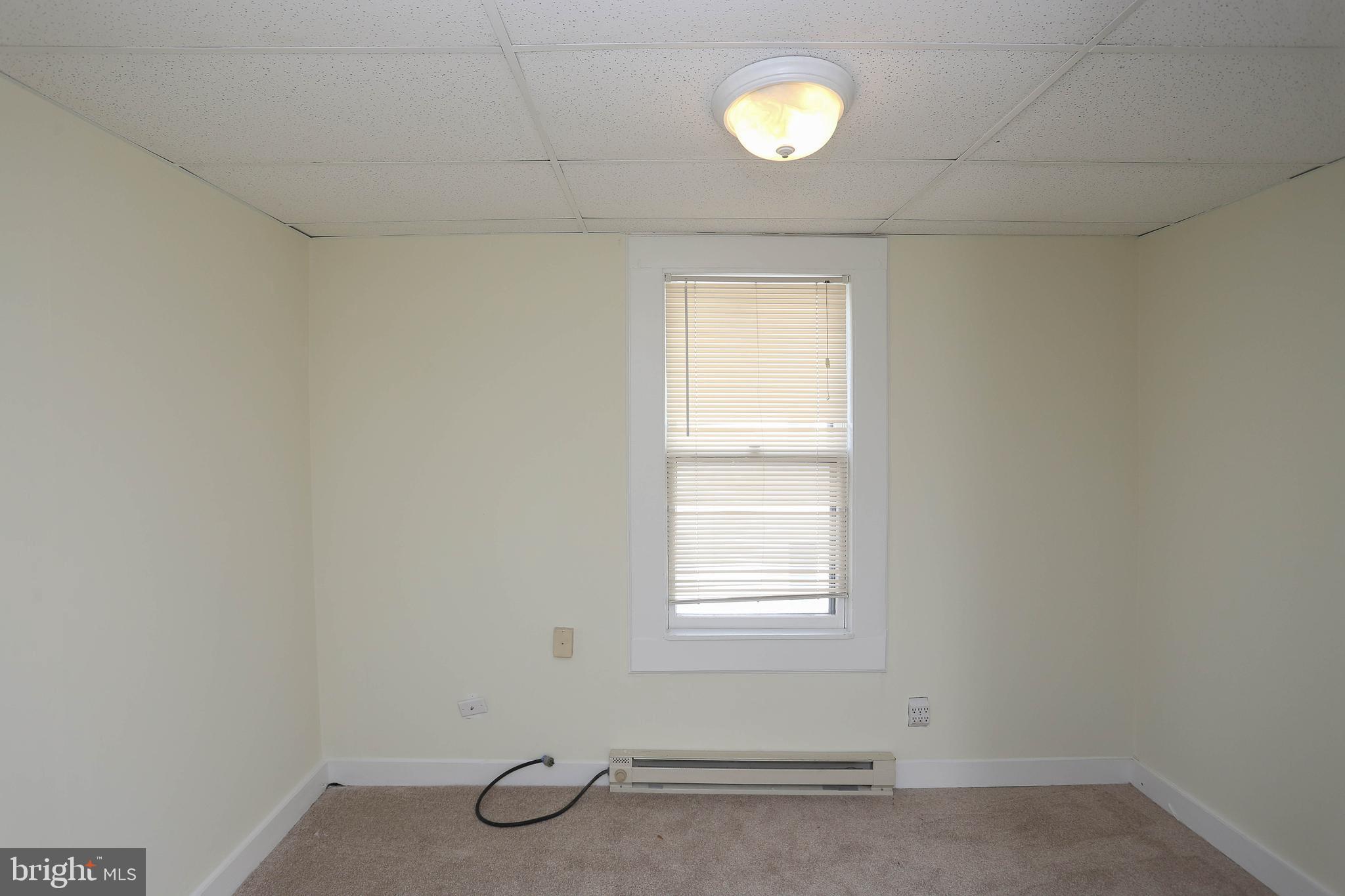 216 Clyde Avenue Halethorpe, MD 21227 - Photo 12 of 49 an empty room with windows