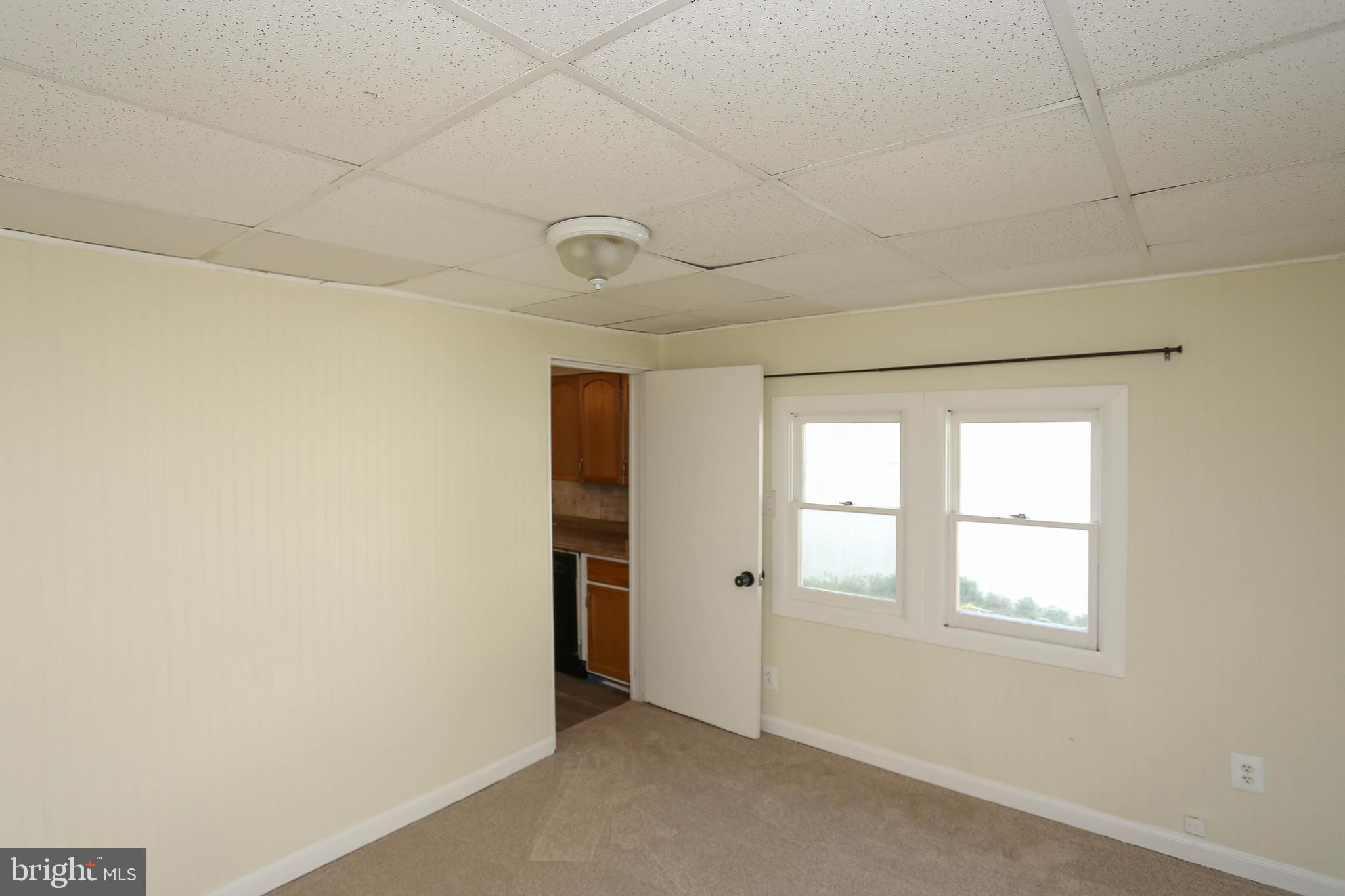 216 Clyde Avenue Halethorpe, MD 21227 - Photo 19 of 49 an empty room with windows