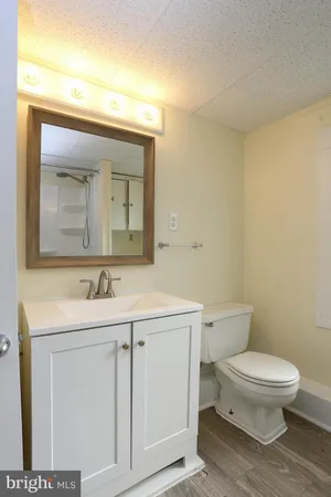 a bathroom with a toilet sink and shower
