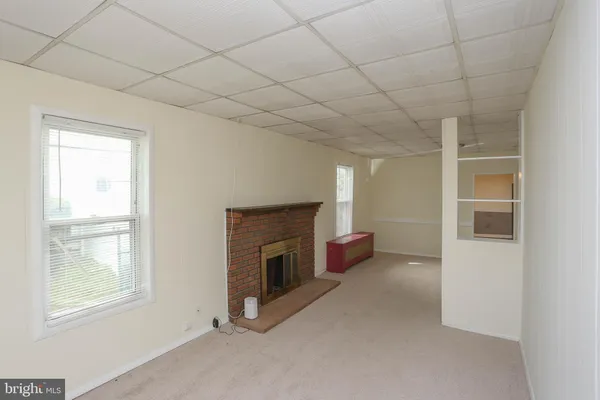 a view of empty room with air conditioner and window