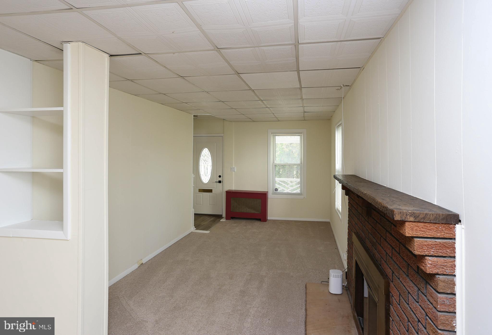 216 Clyde Avenue Halethorpe, MD 21227 - Photo 31 of 49 a view of empty room with a fireplace and window
