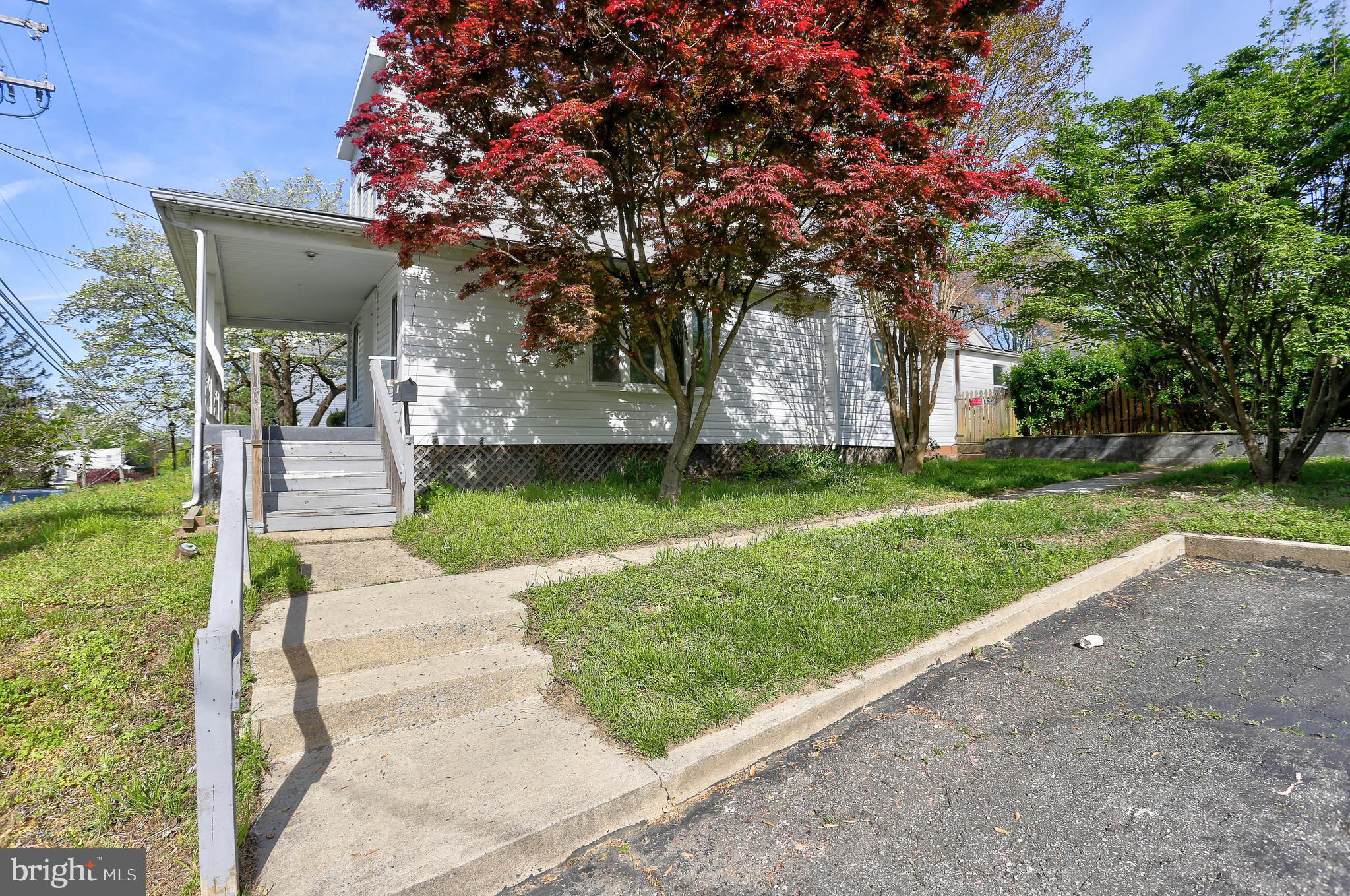 216 Clyde Avenue Halethorpe, MD 21227 - Photo 9 of 49 a front view of a house with a garden and tree
