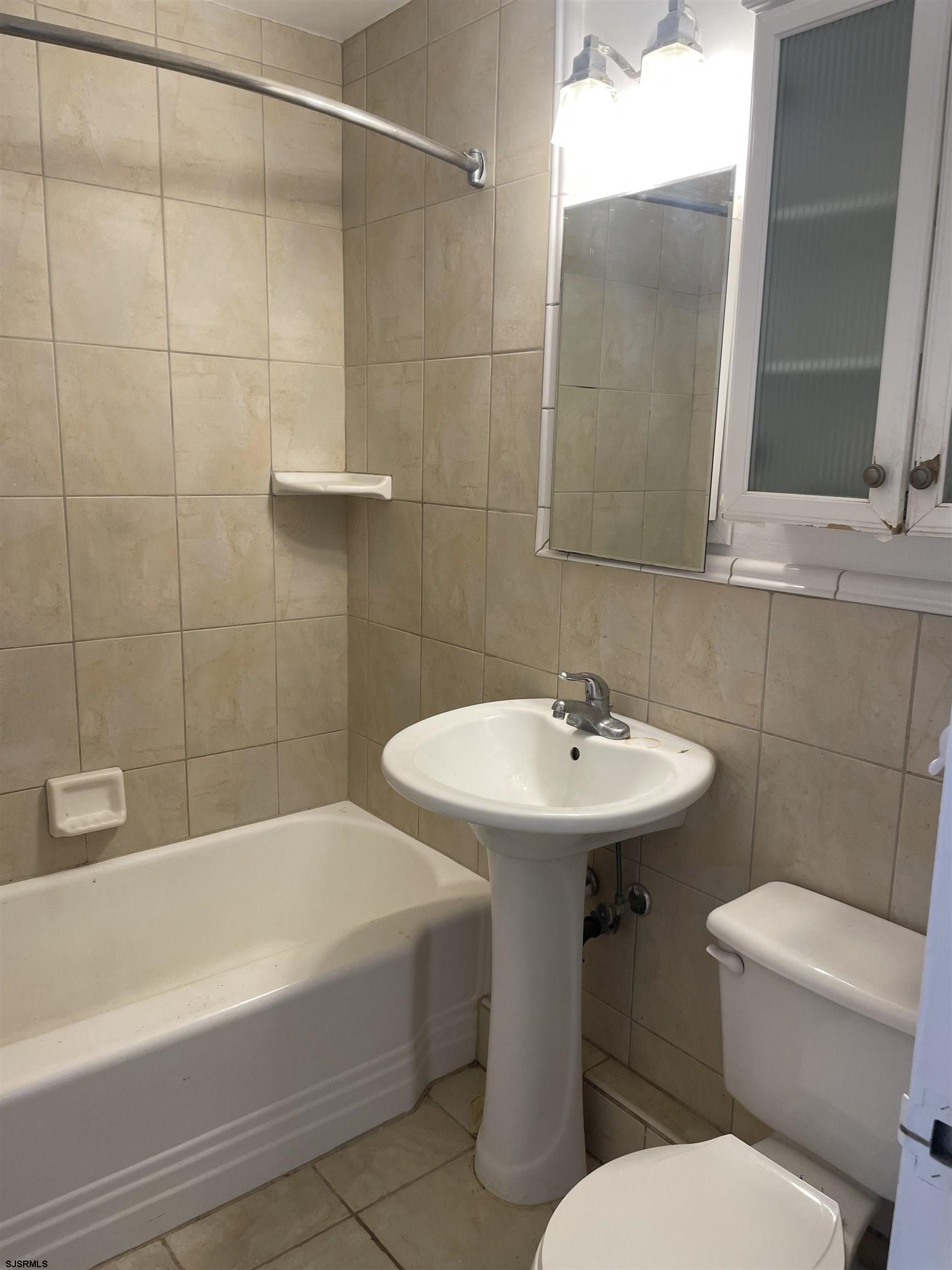 101 South Raleigh Avenue, Unit 618 Atlantic City, NJ 08401 - Photo 14 of 26 a bathroom with a sink a toilet and shower