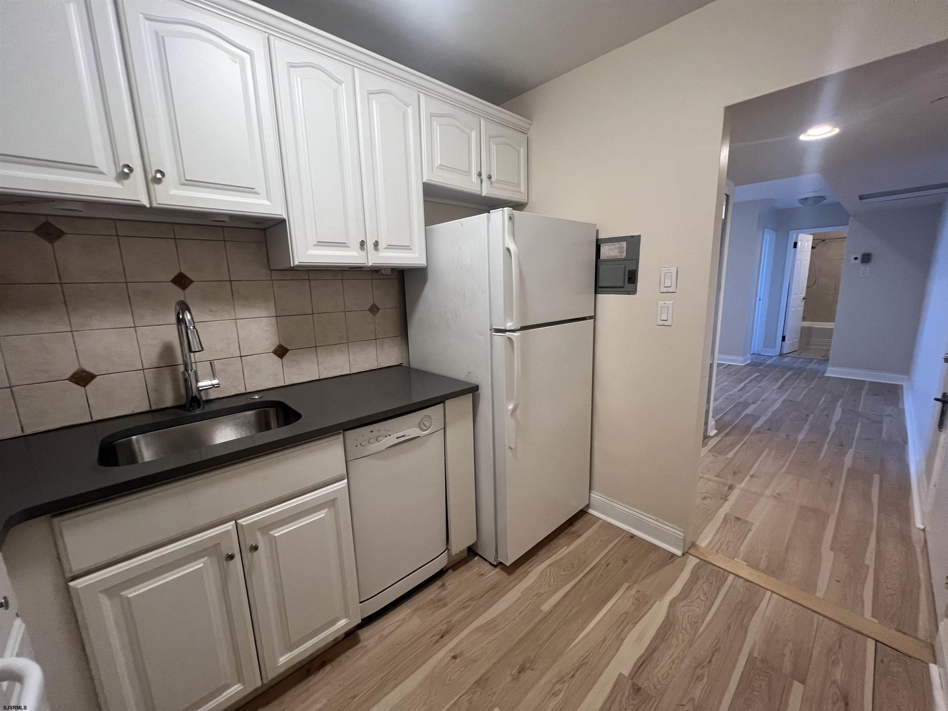 101 South Raleigh Avenue, Unit 618 Atlantic City, NJ 08401 - Photo 6 of 26 a kitchen with a sink a refrigerator and cabinets
