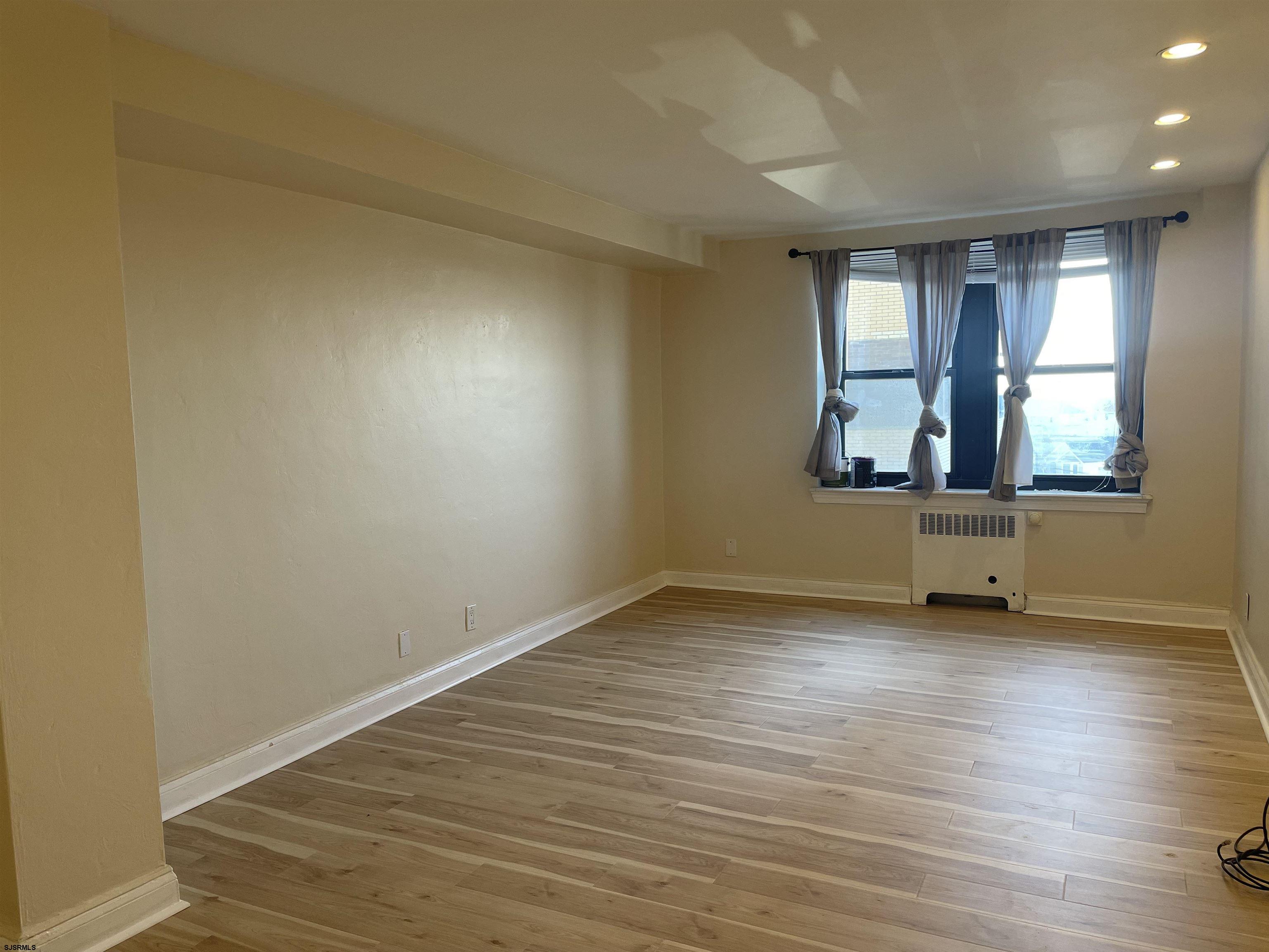 101 South Raleigh Avenue, Unit 618 Atlantic City, NJ 08401 - Photo 10 of 26 an empty room with wooden floor and windows