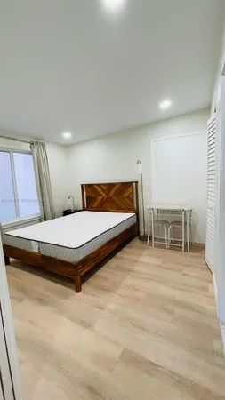 a bedroom with a bed and chair