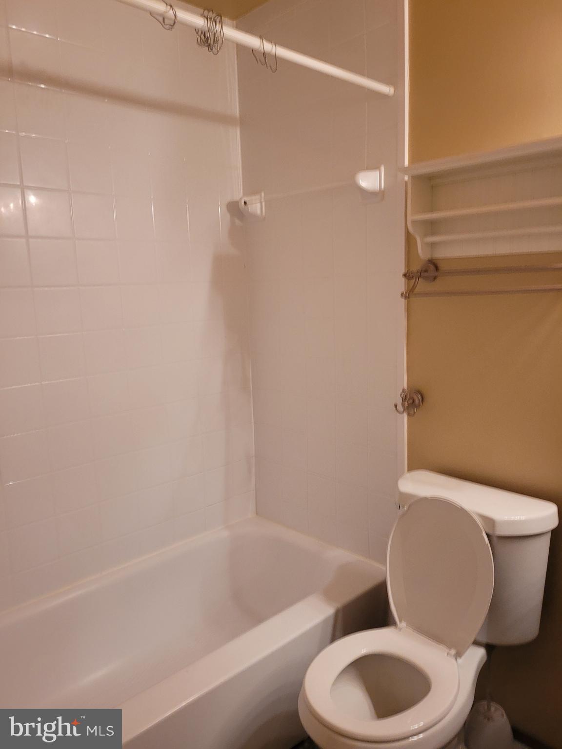 3247 Chester Grove Road Upper Marlboro, MD 20774 - Photo 15 of 17 a white toilet and tub sitting next to a bathroom sink