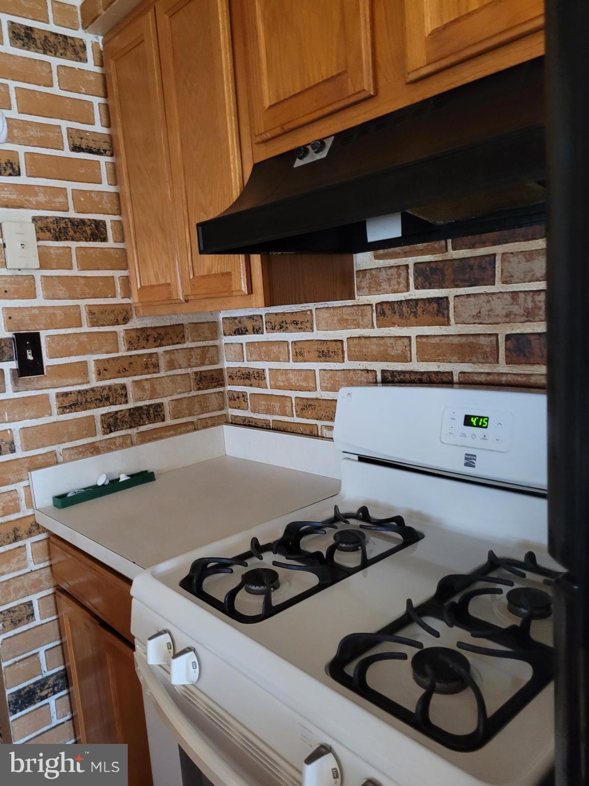 3247 Chester Grove Road Upper Marlboro, MD 20774 - Photo 8 of 17 a kitchen with a stove and a microwave