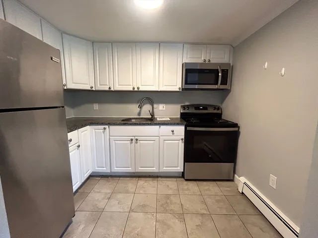 a kitchen with a sink a stove and refrigerator