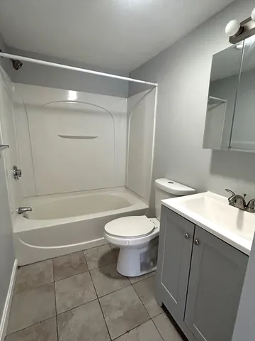 a bathroom with a toilet sink and shower