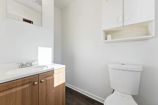 a bathroom with a sink a toilet and a mirror