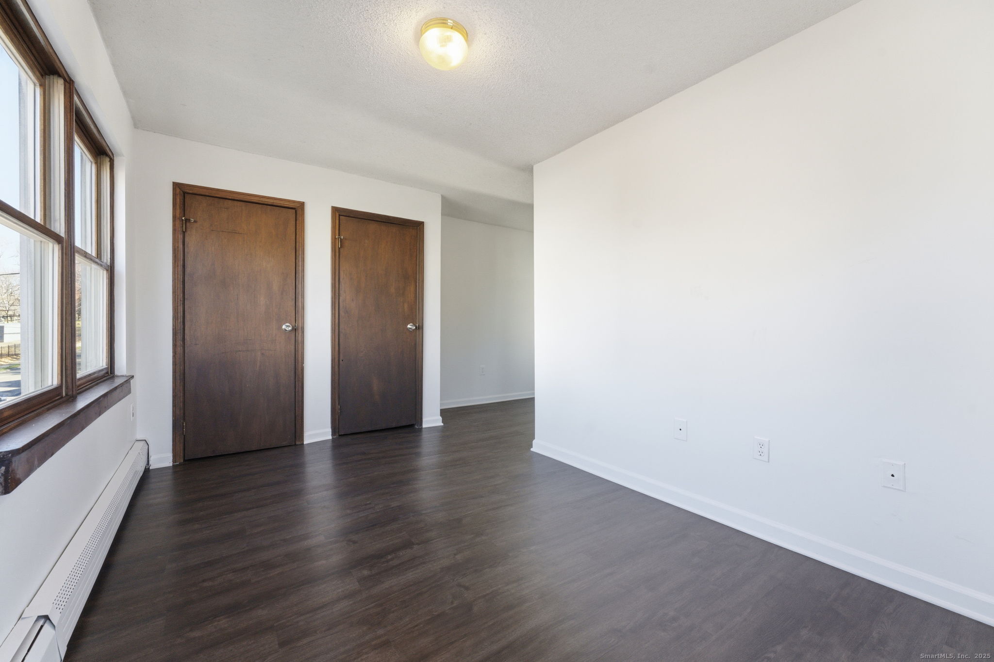 33 Guilford Street, Unit B Hartford, CT 06120 - Photo 12 of 20 an empty room with wooden floor and windows