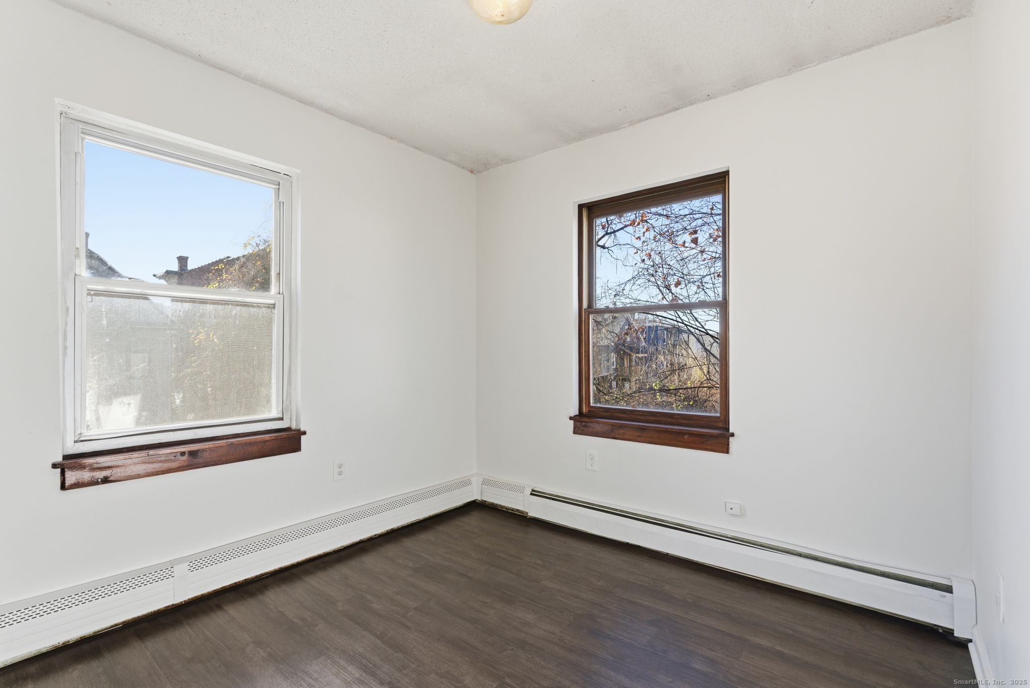 33 Guilford Street, Unit B Hartford, CT 06120 - Photo 13 of 20 an empty room with wooden floor and a window