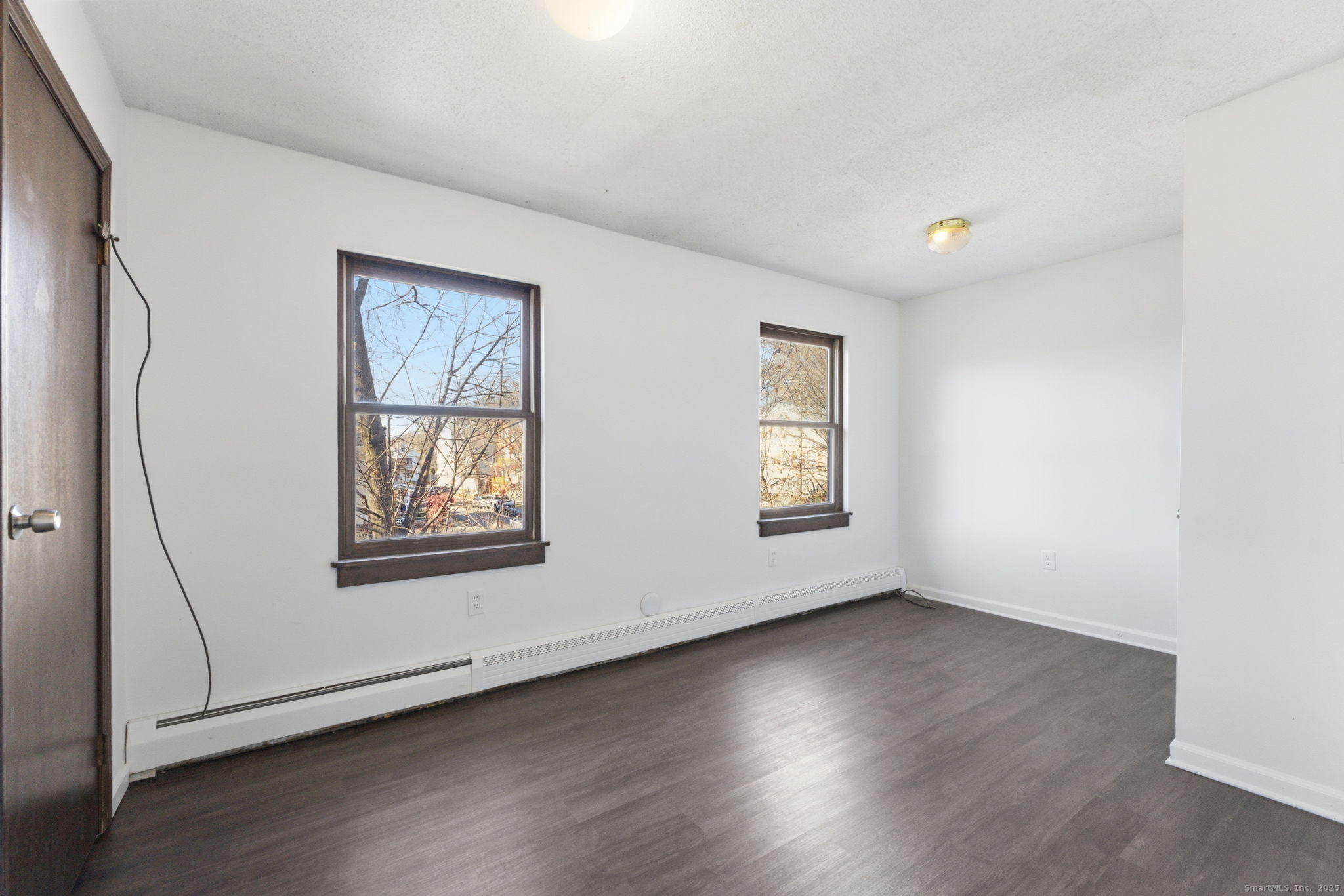 33 Guilford Street, Unit B Hartford, CT 06120 - Photo 15 of 20 a view of an empty room with wooden floor and a window