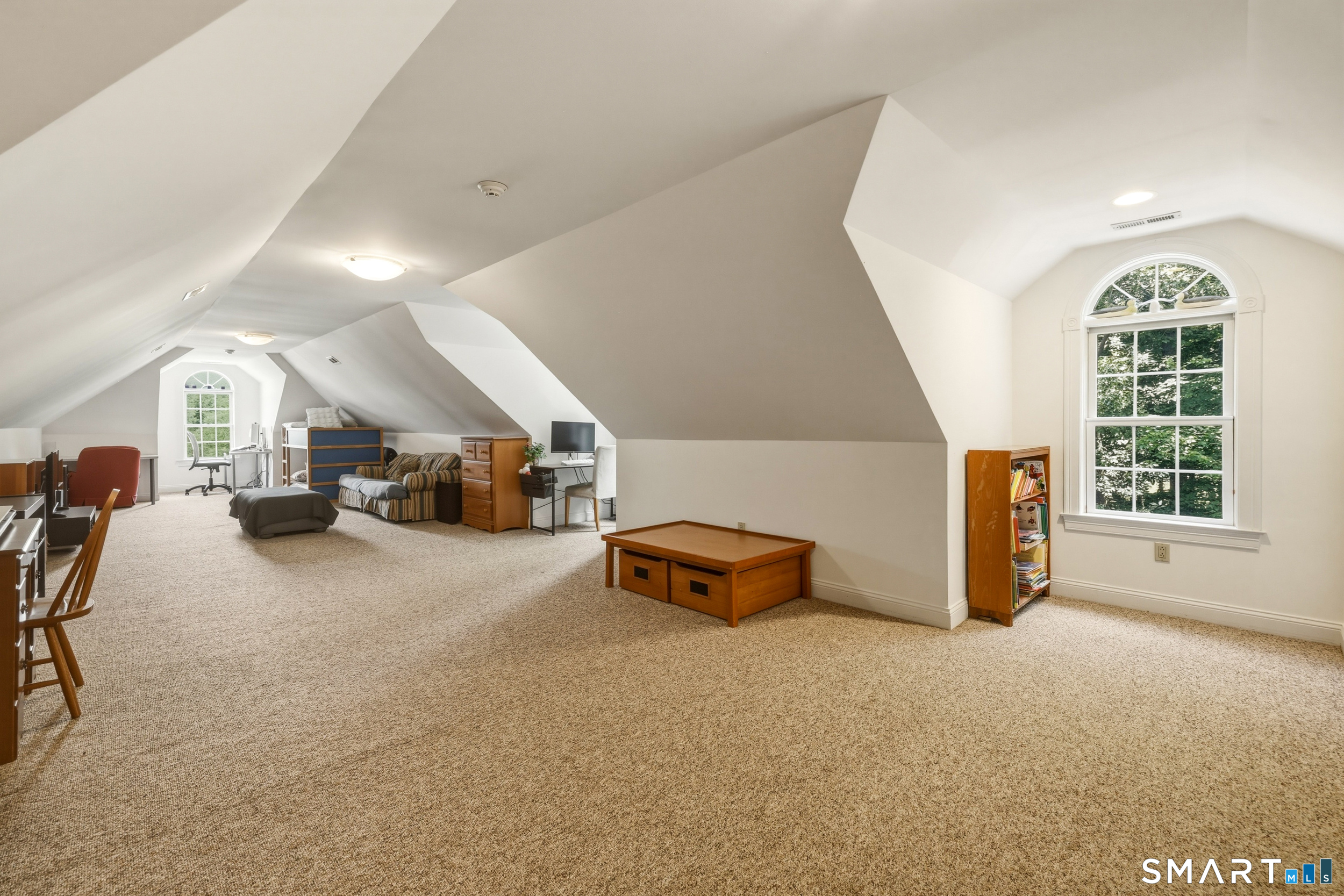 122 Lower Road Guilford, CT 06437 - Photo 27 of 40 The second-floor bonus/rec room features carpet, a vaulted ceiling, and Palladian windows, and storage space.