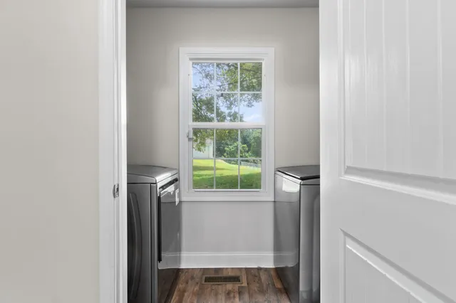 a view of hallway with a window and a kitchen