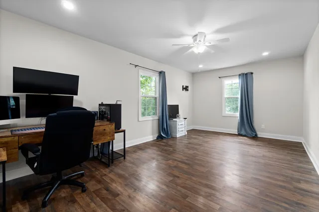 a view of a workspace with furniture and a window