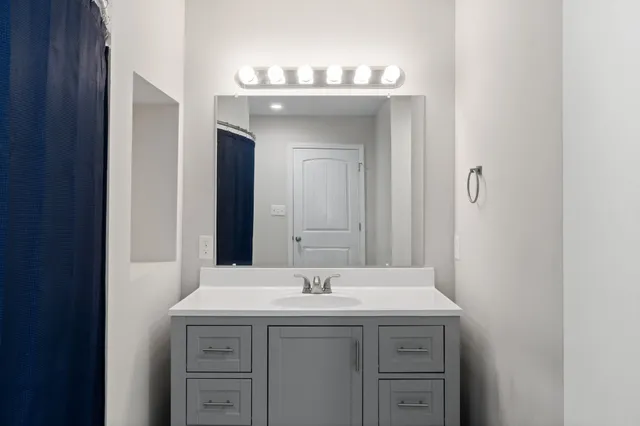 a bathroom with a sink and a mirror