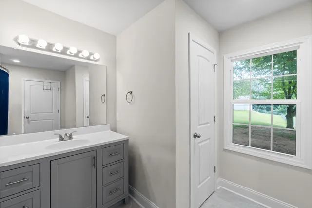 a bathroom with a double vanity sink and a mirror