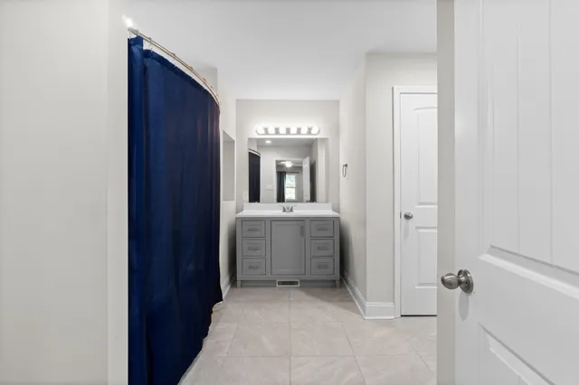a view of a hallway with a bathroom