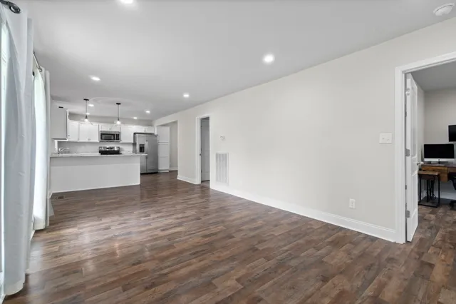 a view of a kitchen with a sink and a refrigerator