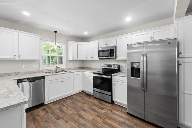 a kitchen with a refrigerator stove and microwave