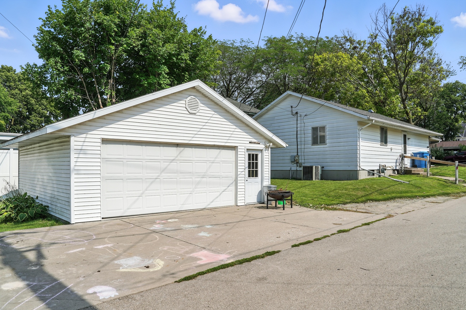 215 East 3rd Street Dixon, IL 61021 - Photo 15 of 16 a view of a house with a yard and garage