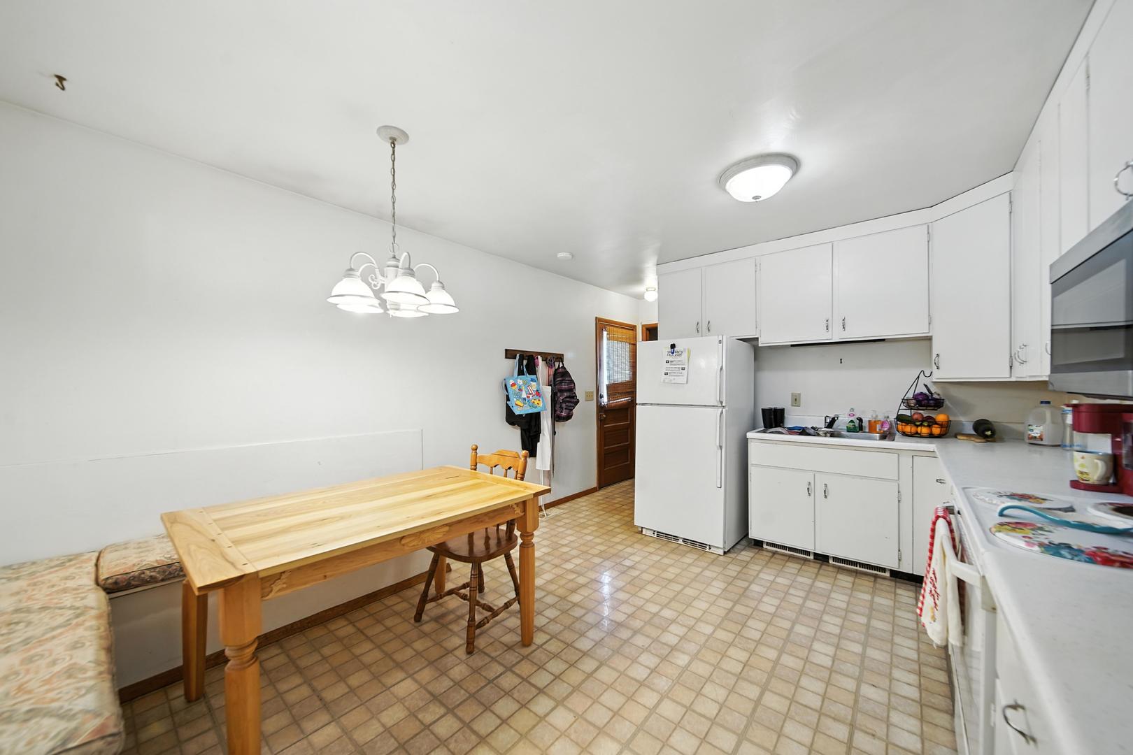215 East 3rd Street Dixon, IL 61021 - Photo 7 of 16 a kitchen with refrigerator and windows