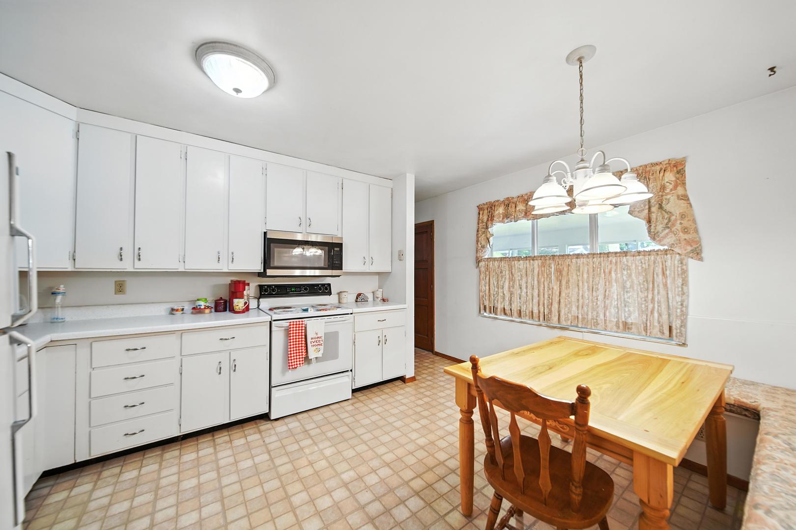 215 East 3rd Street Dixon, IL 61021 - Photo 8 of 16 a kitchen with sink cabinets and window