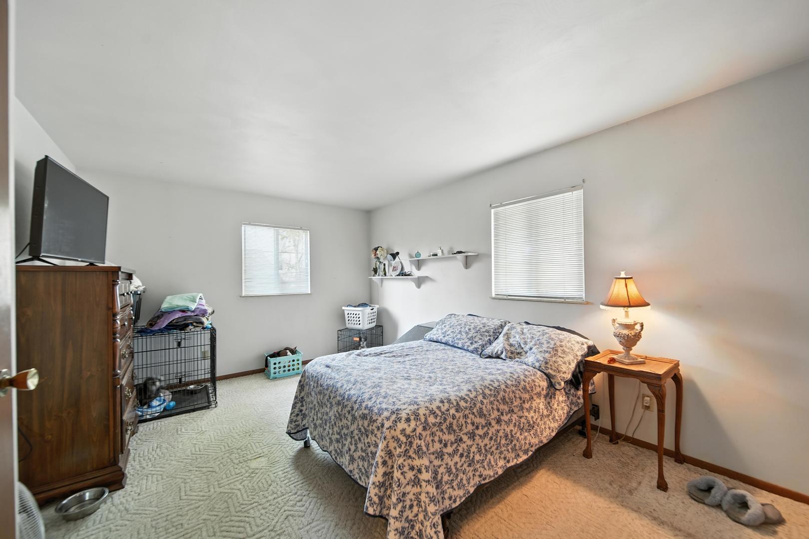215 East 3rd Street Dixon, IL 61021 - Photo 10 of 16 a bedroom with a bed and a tv on table