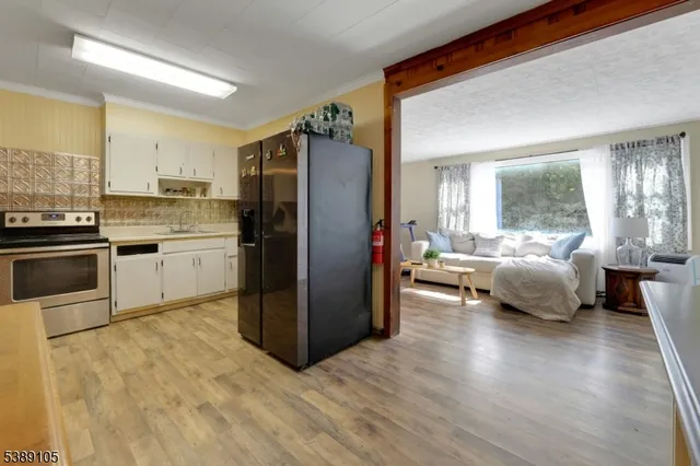 a kitchen with a refrigerator and a stove top oven
