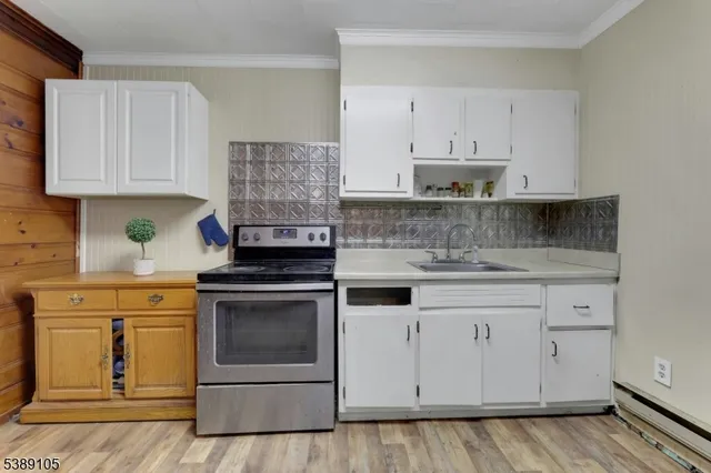 a kitchen with granite countertop white cabinets and white appliances
