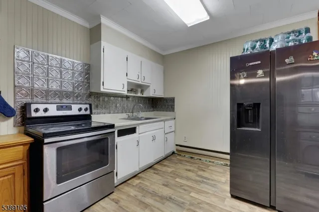 a kitchen with stainless steel appliances granite countertop a stove a refrigerator and a microwave