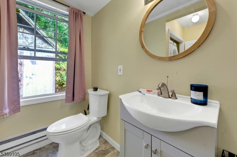 28 Risley Road West Milford, NJ 07421 - Photo 21 of 23 a bathroom with a sink a toilet and a mirror