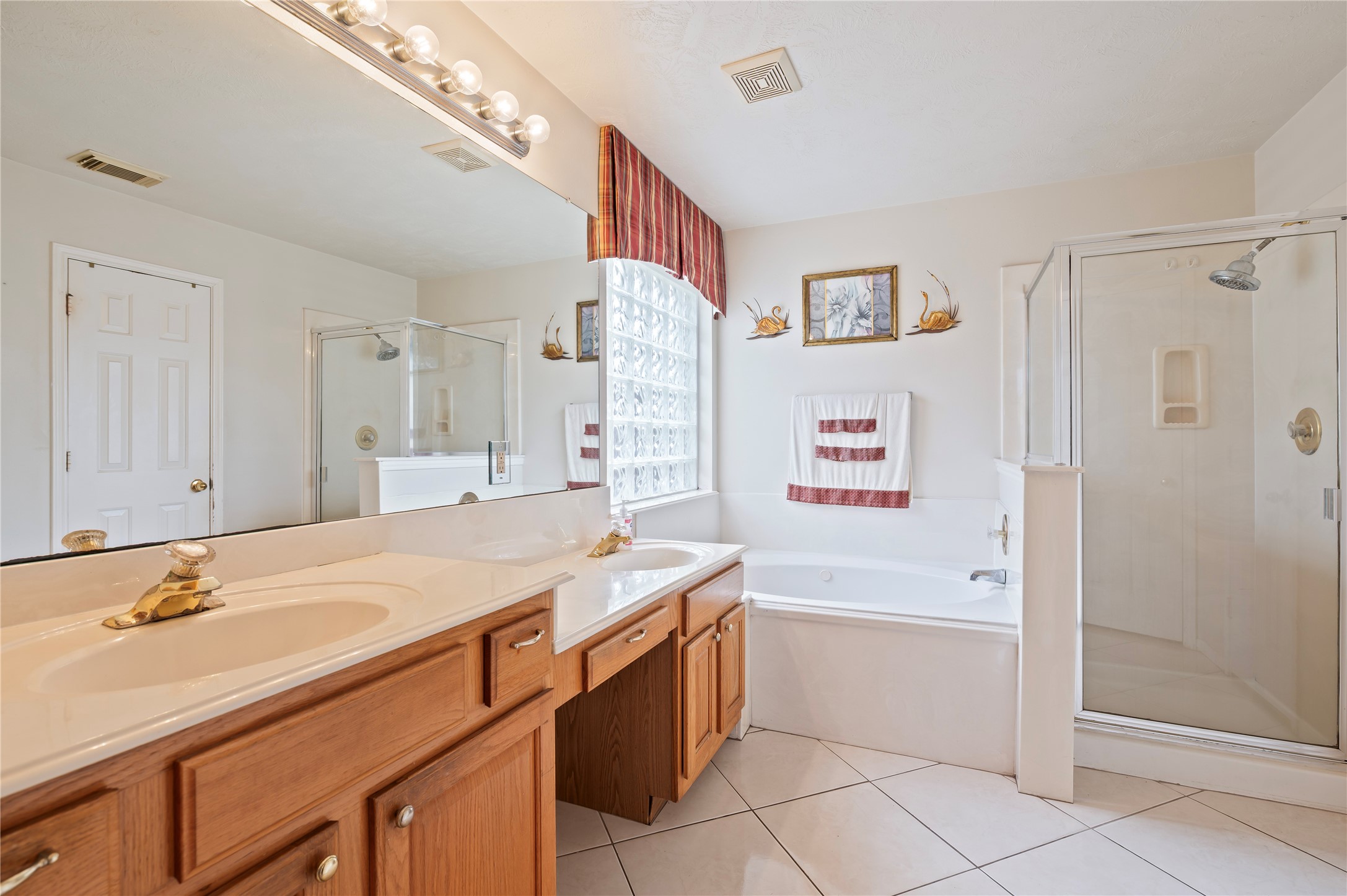 5011 Lakeside Court Pasadena, TX 77504 - Photo 22 of 31 a bathroom with a sink double vanity granite tub shower and a mirror