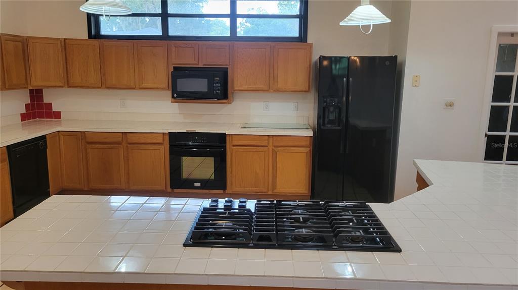 1014 Southeast 10th Street Gainesville, FL 32601 - Photo 6 of 16 a kitchen with stainless steel appliances granite countertop a refrigerator and a stove