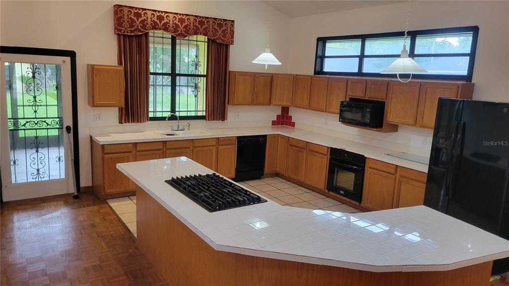 1014 Southeast 10th Street Gainesville, FL 32601 - Photo 7 of 16 a kitchen with stainless steel appliances granite countertop a sink stove and refrigerator
