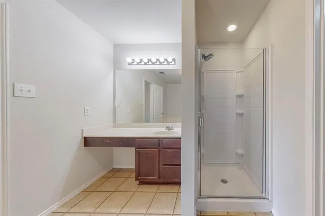 a bathroom with a sink a mirror and a shower