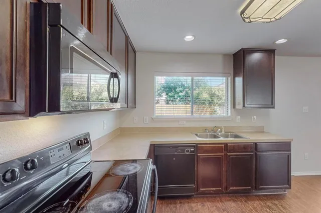 a kitchen with a sink and a stove top oven