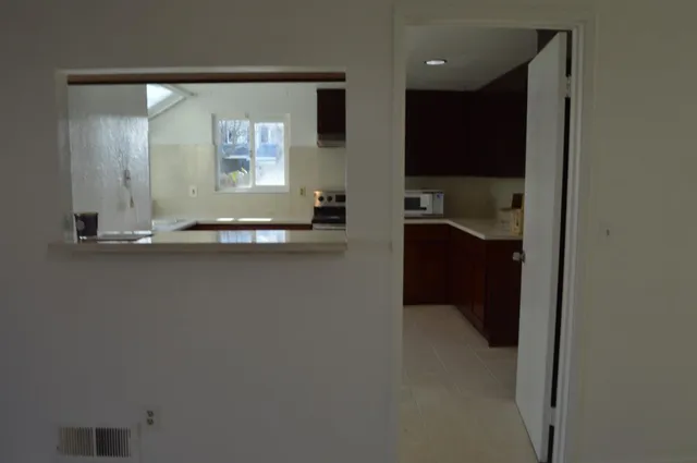 a kitchen with granite countertop a sink and a stove