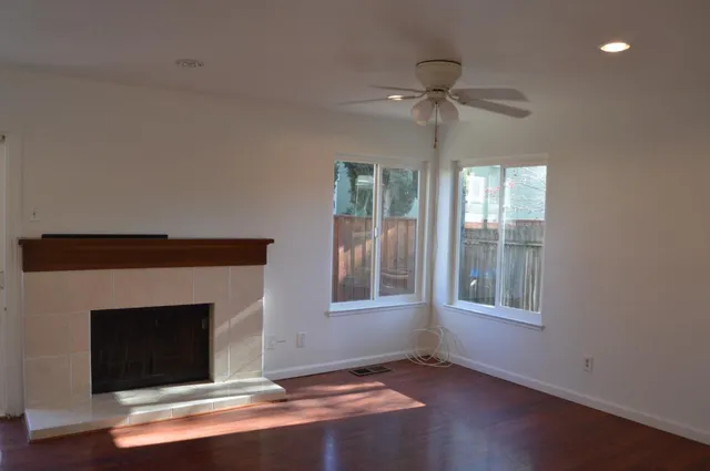 wooden floor in an empty room with a window