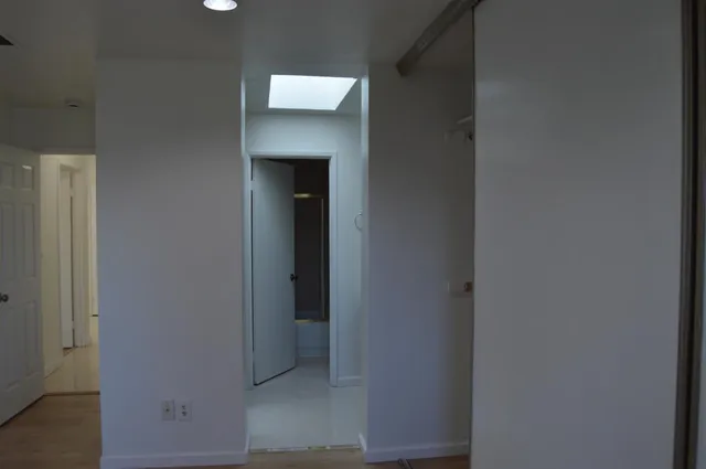 a white toilet sitting next to a shower