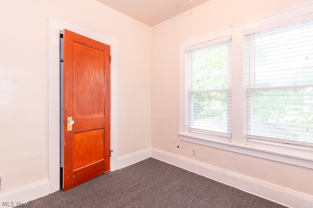917 Helmsdale Road Cleveland Heights, OH 44112 - Photo 18 of 28 Unfurnished room featuring baseboards and dark colored carpet