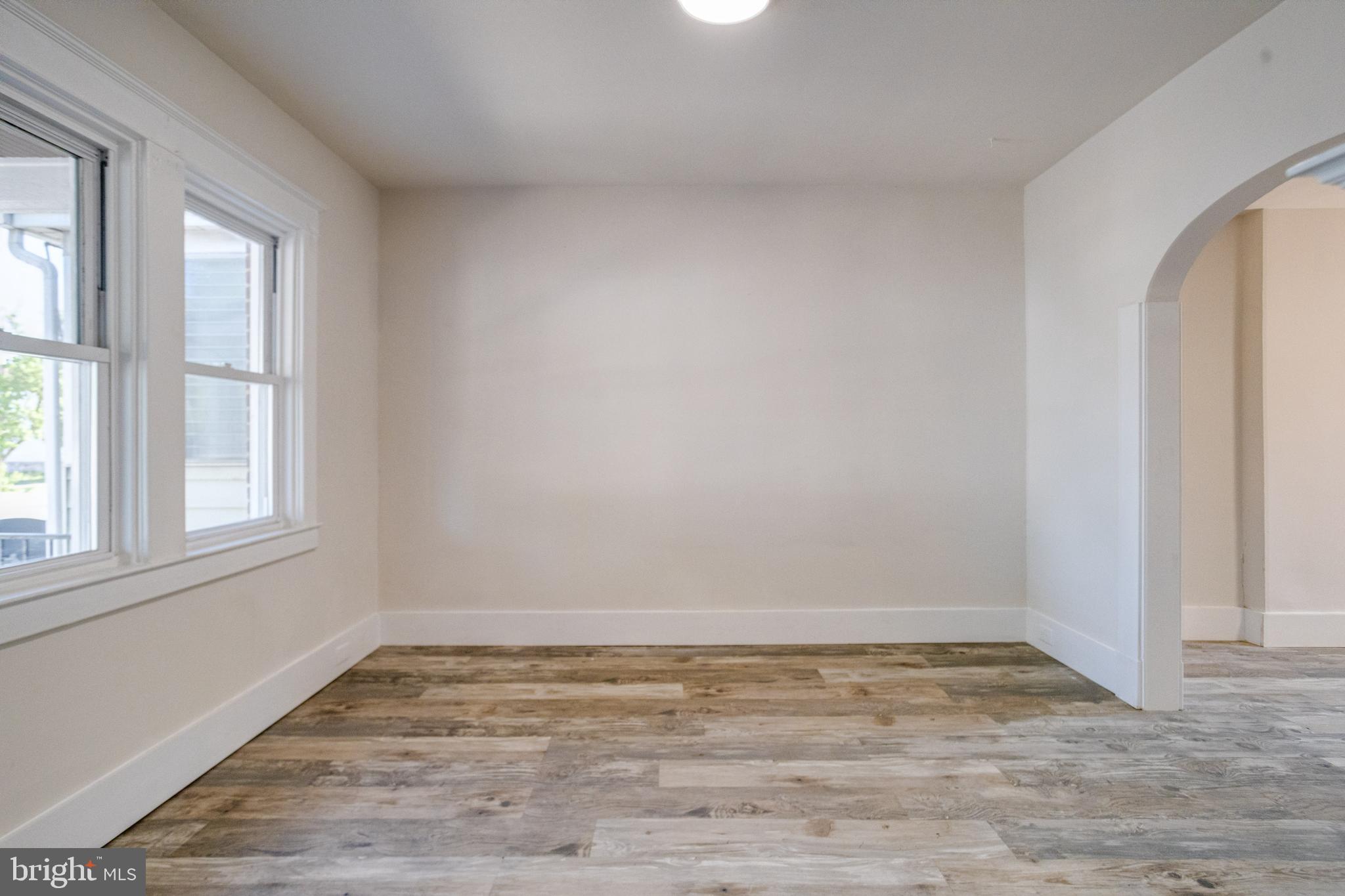 5878 Belair Road Baltimore, MD 21206 - Photo 5 of 41 wooden floor in an empty room with a window
