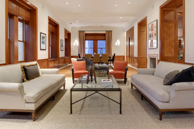 a living room with furniture and a chandelier