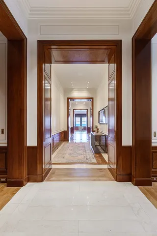 a living room with furniture and floor to ceiling windows
