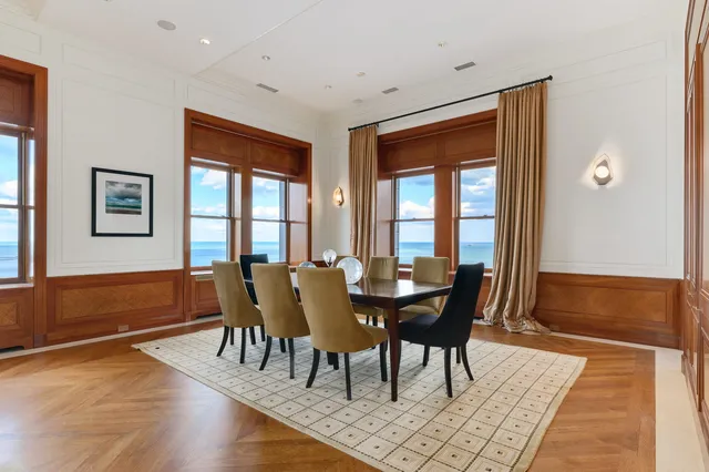 a living room with furniture and floor to ceiling windows