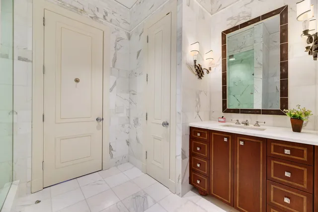 a bathroom with a toilet a sink and mirror