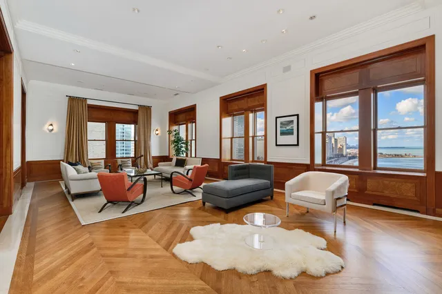 a view of a dining room with furniture a chandelier and wooden floor